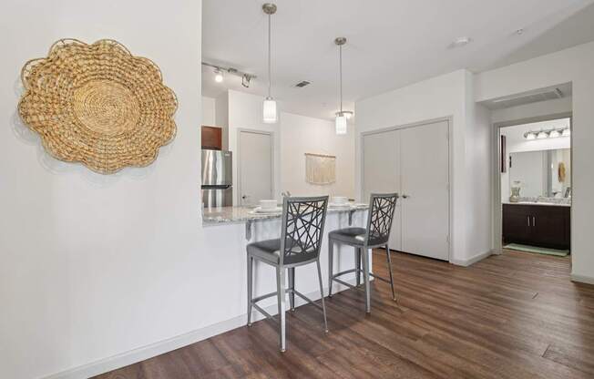 A dining room with a wooden table and chairs.
