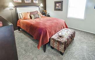 Spacious master bedroom at Ashton Pointe Apartments with a neutral color scheme and windows