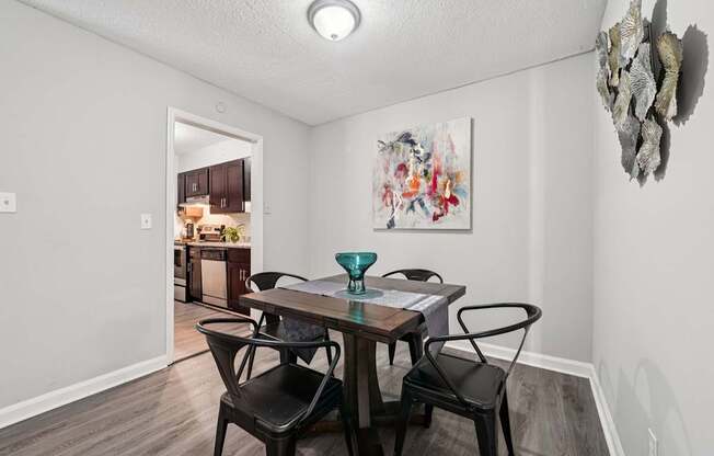 A dining room with a table and chairs.