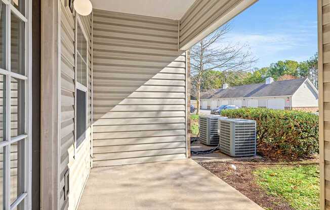 A sunny day at a residential house with a covered porch.