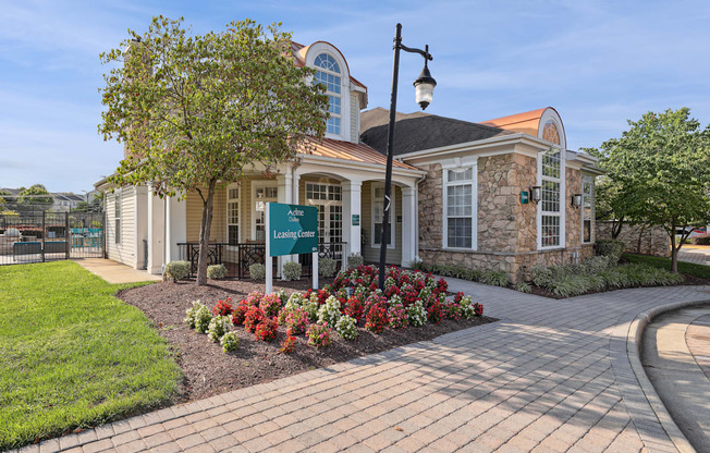 A building with a sign that says Leading Care is surrounded by flowers and greenery.