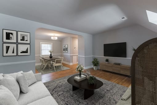 Virtually staged living room with a couch and a table and a tv