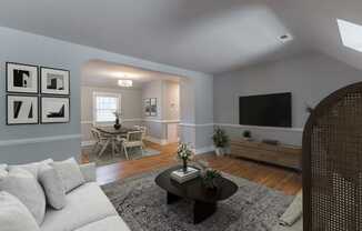 Virtually staged living room with a couch and a table and a tv