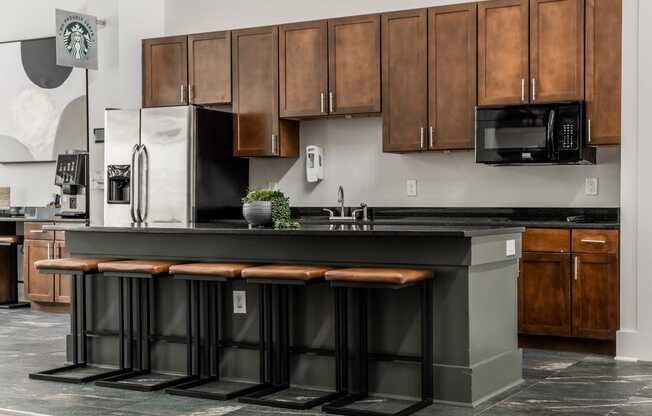 a kitchen with wooden cabinets and a black counter top