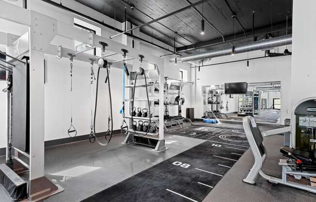 a workout room with weights and equipment in a gym