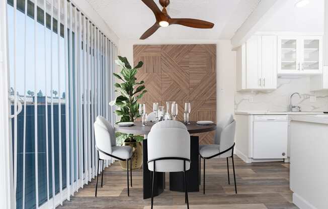 a dining room with a table and chairs and a ceiling fan