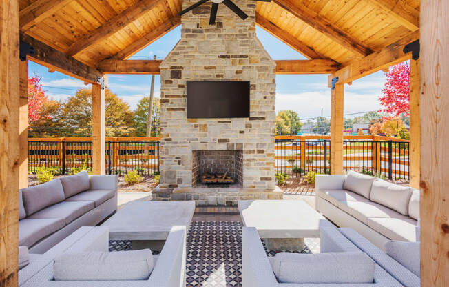 Poolside pavilion with fireplace, TV, and seating area at Bon Haven apartment complex in Spartanburg, SC