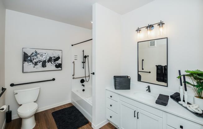 a bathroom with white cabinets and a toilet and a sink at The Crossings at Windsong, Prescott Valley