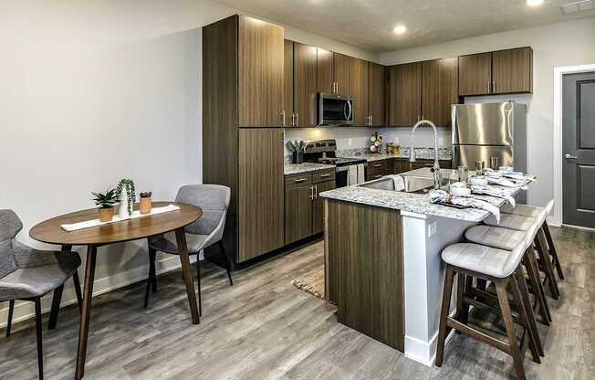 A modern kitchen with a table and chairs.