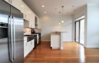 a kitchen with stainless steel appliances and white cabinets