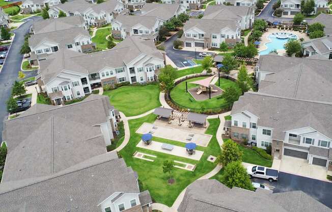 an aerial view of a neighborhood with houses and a fountain