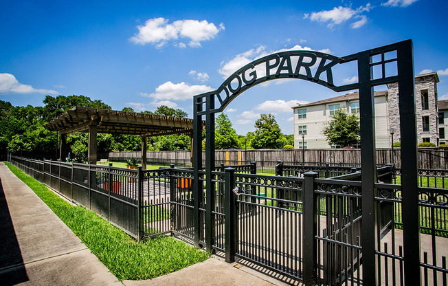 a gate that says hong park with a building and trees in the background