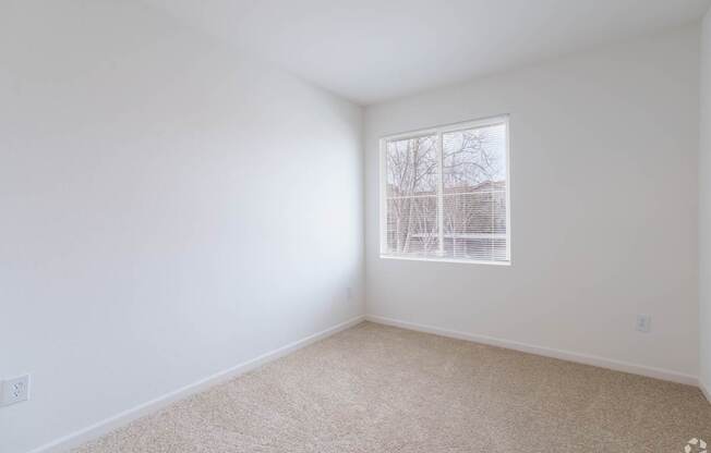 A room with a window and carpeted floor at Cornerstone at Gale Ranch Apartments, California
