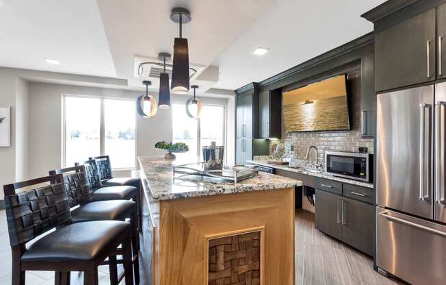 Westwood Green Apartments Clubhouse full demonstration kitchen with stainless appliances and bar height countertop