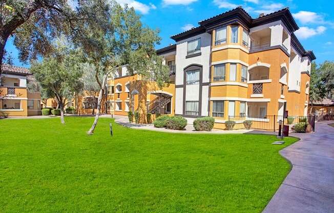A large, modern building with a well-maintained lawn in front.