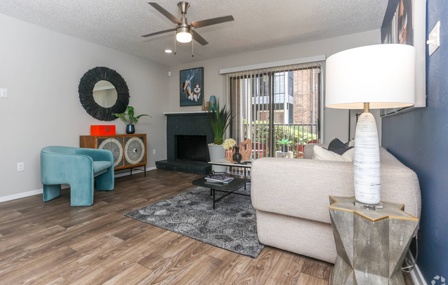 living room with ceiling fan and wood style flooring