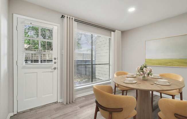 a dining room with a table and chairs