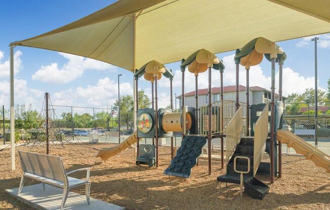 a playground with a swing set and other playground equipment