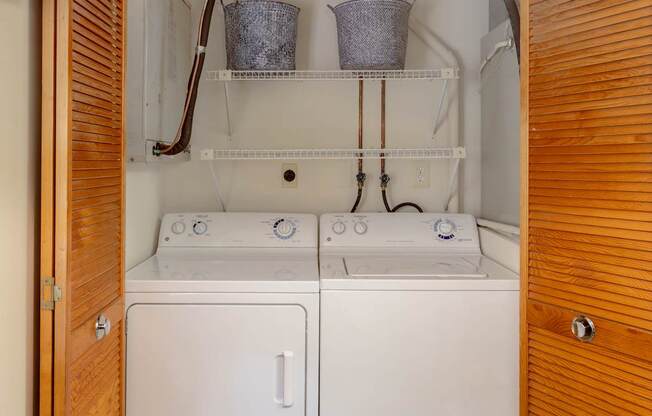 A small laundry room with a washer and dryer.