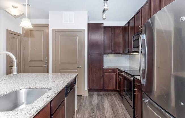a kitchen with stainless steel appliances and granite counter tops