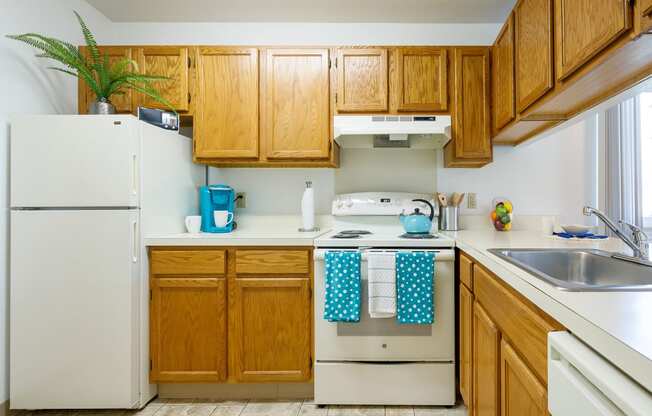 a kitchen with white appliances and wooden cabinets