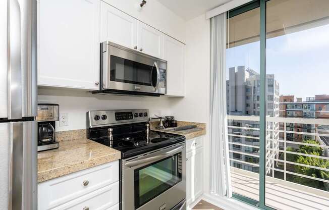 A kitchen with white cabinets and stainless steel appliances.