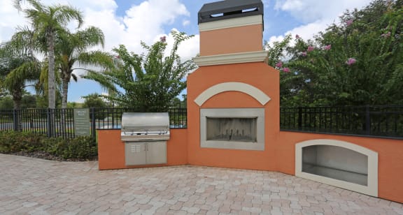 Unique poolside fireplace and grilling station at The Columns at Bear Creek, New Port Richey, Florida 34654