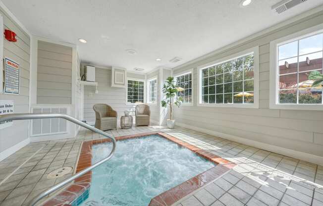 a hot tub in a room with a large window