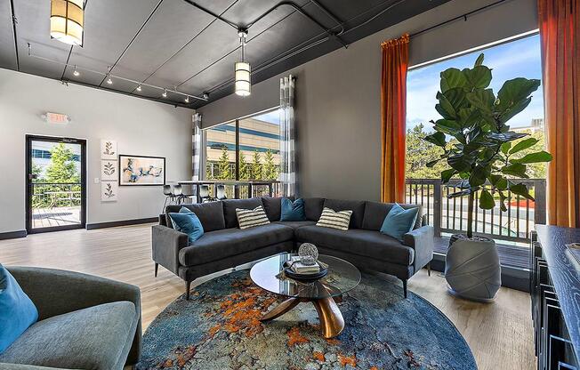 a living room with couches and a table at Troy Place Apartments - Troy, MI, Troy, Michigan