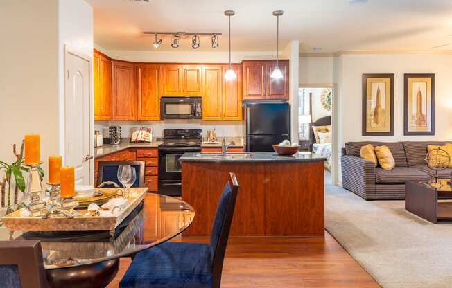 a kitchen and living room with a table and chairs