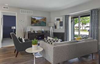 a living room with a couch and chairs and a fireplace