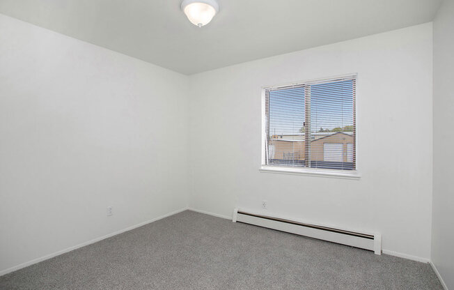 bedroom with a window and a carpeted floor