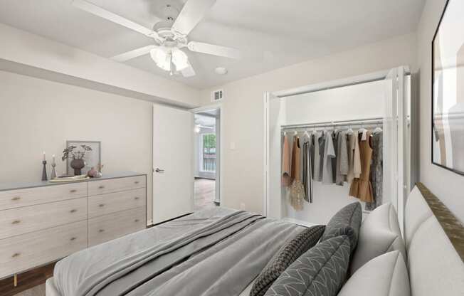 a bedroom with a bed and a closet at Woodlands of Plano in Plano, TX