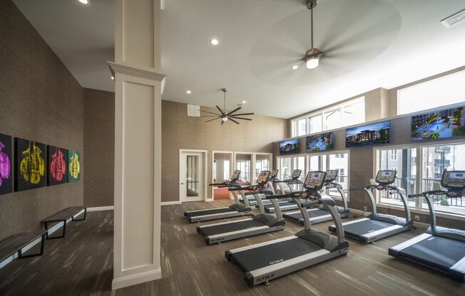 A gym with treadmills and exercise bikes.
