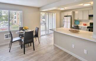 a kitchen and dining area with a large window  at 3030 Lake City, Seattle, 98125