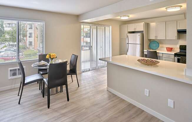 a kitchen and dining area with a large window  at 3030 Lake City, Seattle, 98125