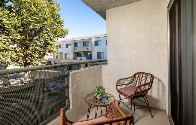 A balcony with a chair and table.