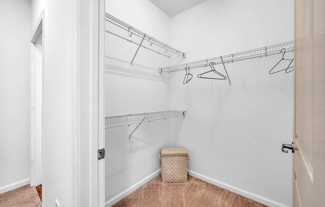 an empty closet with a basket in the corner of it