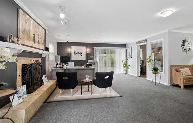 A modern office space with a reception desk and two chairs.
