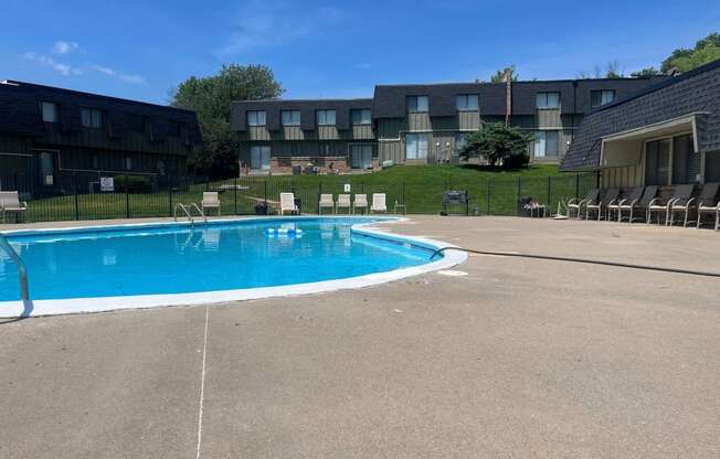 a swimming pool in front of an apartment building