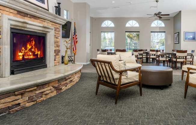 a room with a fireplace and a table and chairs