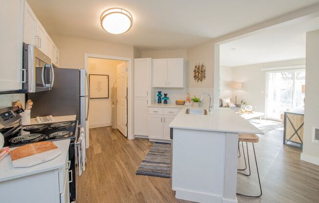 a kitchen with a white counter top and a refrigerator