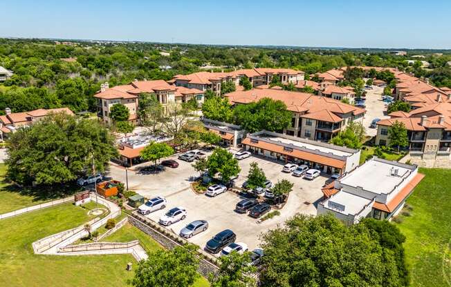 an aerial view of a parking lot and buildings in a city