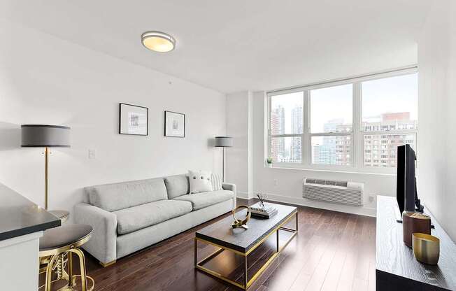 Living room with white couch1 at 65 Bay Street, Jersey City, NJ