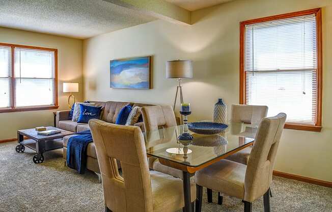 a living room and dining room with a couch and a table