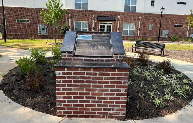 a monument in front of a brick building