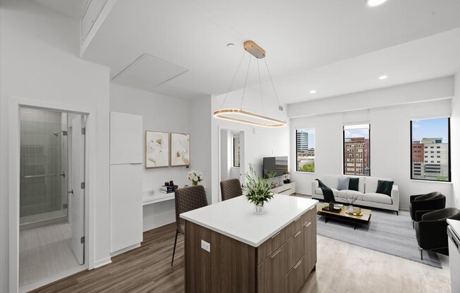 A modern kitchen with a white countertop and wooden cabinets.