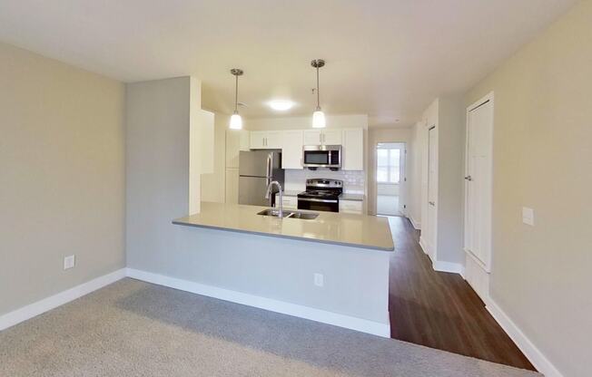 kitchen view from a living room at Signature Pointe Apartment Homes in Athens, AL