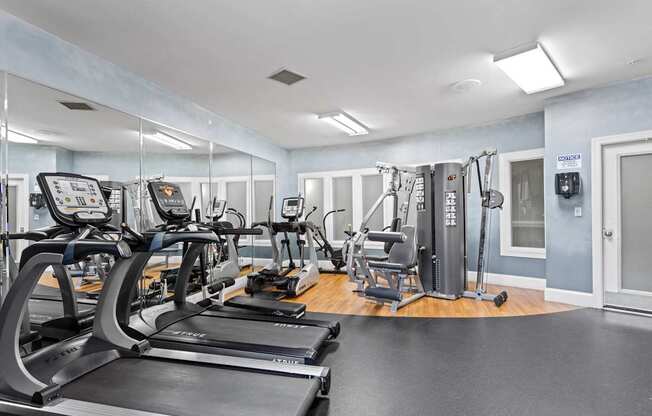 Ten05 West Trade's fitness center with two treadmills, an elliptical and a multifunctional machine