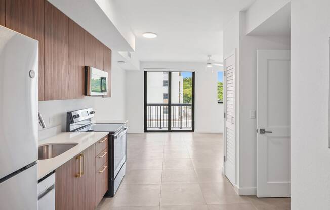a kitchen with wooden cabinets and a white tiled floor